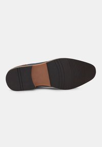 Shoe sole with a black rubber bottom, brown leather accent, and horizontal grooves for traction. The overall shape is flat and oval.