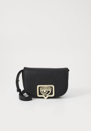Borsa a tracolla in pelle nera con finitura testurizzata. Caratterizzata da un accento hardware color oro a forma di occhio e una chiusura geometrica.