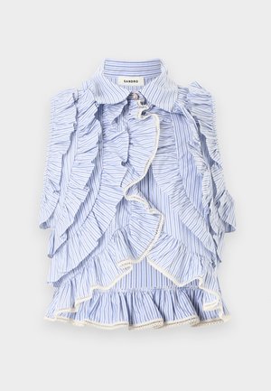 Μπλε και λευκή ριγέ αμάνικη μπλούζα με βολάν που κυλούν κατά μήκος του εμπρός μέρους και στις άκρες, με μυτερό γιακά και ετικέτα με το λογότυπο της μάρκας στο εσωτερικό.