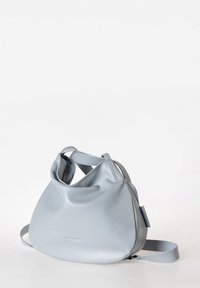 Helleblaue Ledertasche mit einem weichen, lässigen Design. Runde Form, verstellbarer Tragegurt und minimale Hardware-Details.