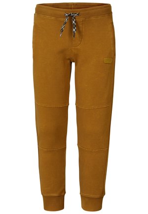 Brune skrå sweatpants med ribbet kant og linning, med sort og hvid snor og lille præget patch på låret.