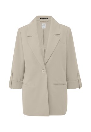 Beżowa marynarka z kołnierzem z wycięciem, zapięciem na pojedynczy guzik oraz rękawami długości do połowy przedramienia, podwiniętymi do góry. Posiada przednią kieszeń i gładką fakturę.