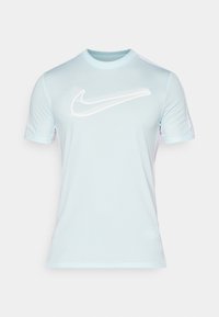 Light blue athletic t-shirt made from smooth fabric, featuring short sleeves and a white Nike logo across the chest.