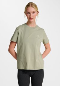 Ljus olivgrön bomullst-shirt, rundhalsad, kortärmad, med en liten guld grafisk detalj på bröstet och en avslappnad passform.