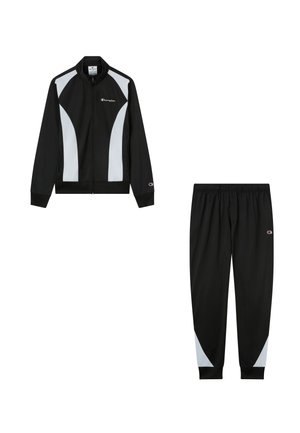 Black and white Champion tracksuit set with zip-up jacket featuring white side panels and matching black pants with white accents at the calves.