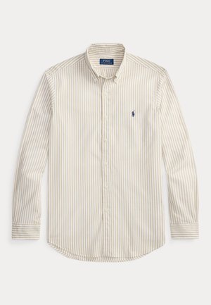 Koszula na guziki w paski w kolorze beżowym i białym, z długimi rękawami, z zaokrąglonym dołem i małym granatowym logo na lewej piersi. Materiał bawełniany.
