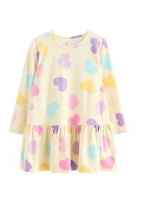 Gul kjole med lange ærmer, en flagrende kant og pastelfarvede hjerte mønstre i pink, blå, lavendel og gul. Blødt, tekstureret stof.