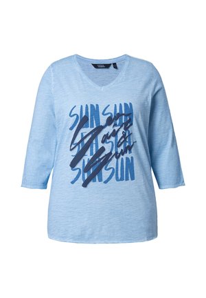 Light blue V-neck shirt with three-quarter sleeves featuring dark blue text "SUN" repeated and bold script overlay.
