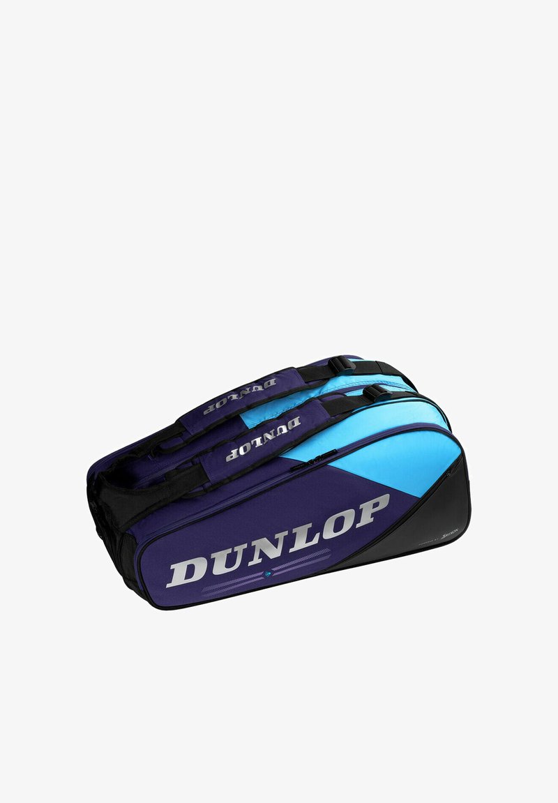 Bolsa deportiva Dunlop de doble compartimento en azul y negro con correas de transporte y nombre de la marca visible en el lateral.