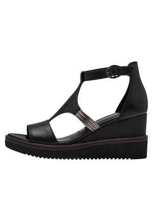 Sandalo wedge nero con tomaia in pelle liscia, punta aperta, cinturino alla caviglia con fibbia e accenti metallici decorativi. Suola testurizzata.