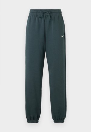 Tamnozelene Nike hlače za trčanje izrađene od mekog materijala, s elastičnim pojasom i podesivom vezicom te sužetak na rubovima.