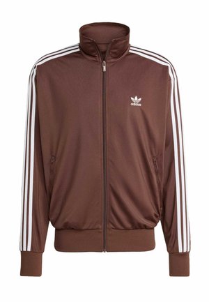 Veste zippée marron Adidas avec des détails à trois bandes blanches sur les manches et un petit logo Adidas sur la poitrine gauche.
