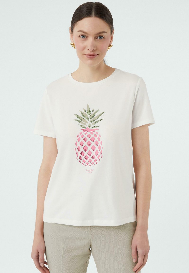 White cotton t-shirt featuring a pink and green pineapple graphic. Short sleeves and a round neckline. Smooth texture, casual fit.