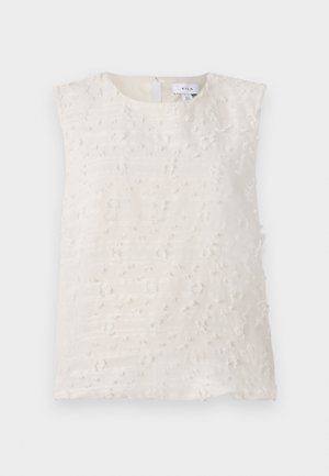 Sleeveless light beige top with textured surface, featuring raised irregular patterns and a back keyhole opening. No visible hardware.