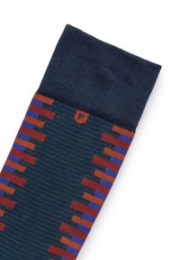 Calcetín multicolor con parte superior azul oscura. Presenta un cuerpo con un patrón de rayas en verde oscuro, naranja y púrpura. Fabricado con un material de punto texturizado.