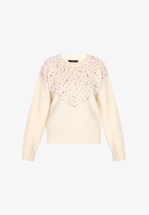 Pull crème avec un col rond, des manches longues et un design texturé présentant des embellissements en gemmes colorées sur le devant.