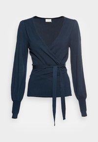 Navy blue wrap top made from soft, stretchy material. Features long sleeves, a V-neck, and a tie belt at the waist. Ribbed cuffs.