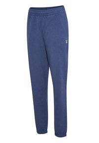 Marineblauwe joggingsbroek met een elastische tailleband, aansluitende boorden en een klein, licht logo-detail aan de zijkant. Gemaakt van zachte katoenstof.