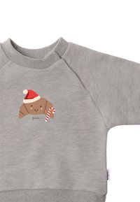 Gray cotton sweatshirt with ribbed neckline and cuffs, featuring a brown croissant character wearing a red Santa hat and holding a candy cane.