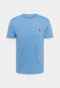 Light blue t-shirt made of cotton, featuring a crew neck and short sleeves. It has a small red embroidered logo on the chest.