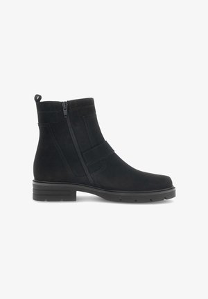 Black ankle boot made of suede, featuring a side zipper, elastic strap, rounded toe, and a textured rubber sole with slight heel.