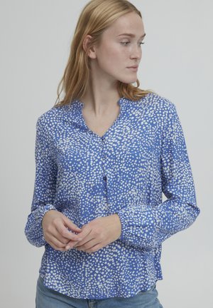 Blue long-sleeve blouse with a button-down front and a dotted white pattern. Lightweight fabric with a relaxed fit and cuffed sleeves.