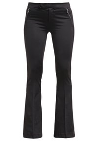 Svarta, utsvängda byxor i ett mjukt, elastiskt tyg. Har två framfickor med dragkedja och en åtsittande midja, vilket ger en skräddarsydd look.