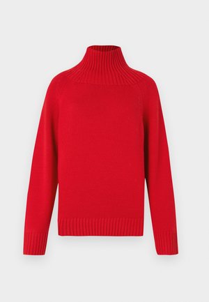 Rød strikket høyhalset genser med ribbestrikket krave og mansjetter. Har en boksformet silhuett og strukturert stoff, som gir et koselig utseende.