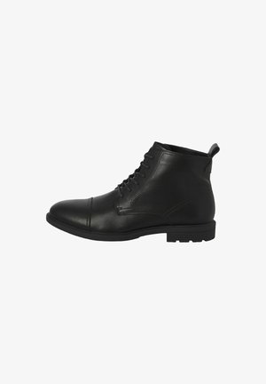 Black leather ankle boots with a round toe, lace-up design, and a pull tab at the back. Features a textured finish and rubber sole.