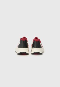 Sneakersne har et sort, hvidt og burgundy farveskema, med en tekstureret stofoverdel, polstret sål og et strømlinet design.