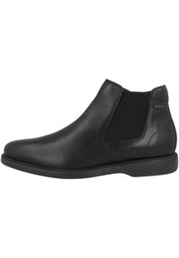 Botines de cuero negro con paneles elásticos en los laterales, punta redondeada y un acabado suave. Suela baja de goma con detalles texturizados mínimos.