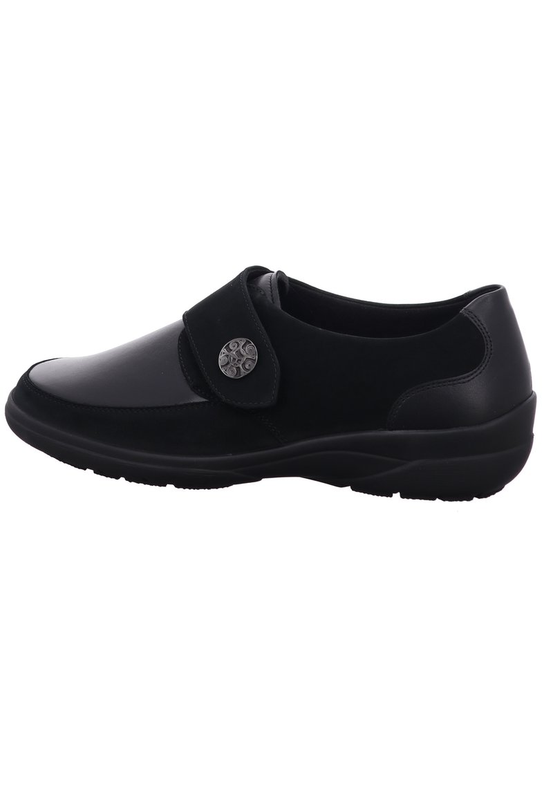 Black shoe with a smooth leather toe and soft suede body, featuring a round metal accent and a Velcro strap for easy fastening.
