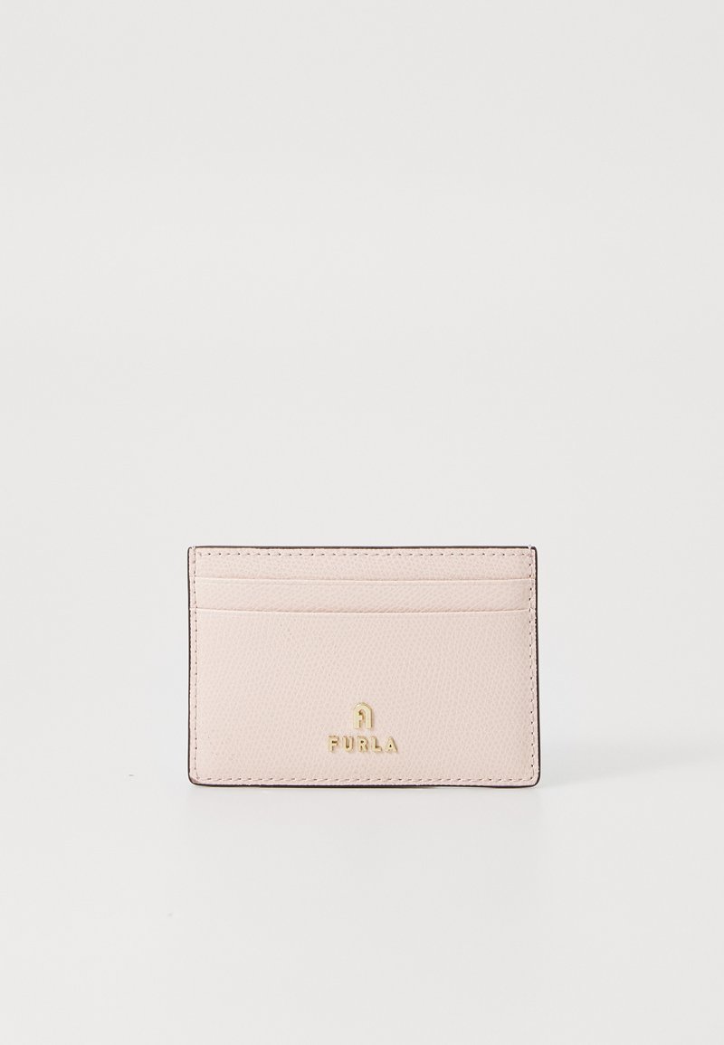 Furla cardholder in light pink leather with textured finish, featuring four slots and gold logo detail at the bottom center.