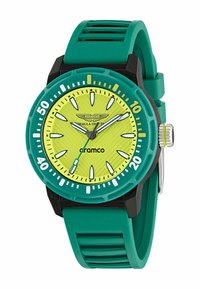 Zeleno-čierny silikónový hodinky s jasne žltým ciferníkom, luminiscenčnými ručičkami a minutovými značkami, s textúrovaným vzorom na ciferníku a akcentom loga.