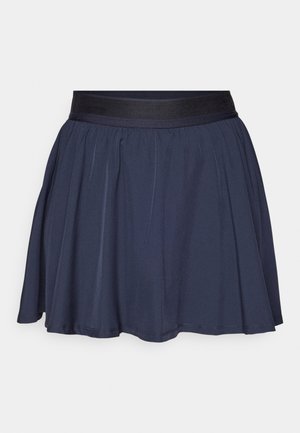 Meripuku tummansinisellä elastisella vyötäröllä. Varustettu laskoksilla, jotka luovat levenevän siluetin. Sujuva, kevyt kangas, jossa on yksivärinen pinta.