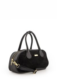 Black handbag featuring a suede body and leather details, rounded shape, dual handles, gold zipper, and detachable shoulder strap.