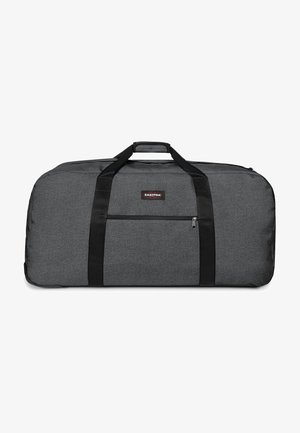 Borsa duffel grigia realizzata in tessuto testurizzato, con doppi manici neri, una tasca laterale con zip e una patch del logo sul davanti.