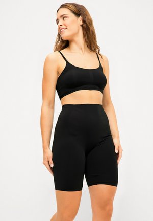 Black seamless crop top and high-waisted shorts made of smooth, stretchy fabric. Both items feature a form-fitting design and adjustable straps.