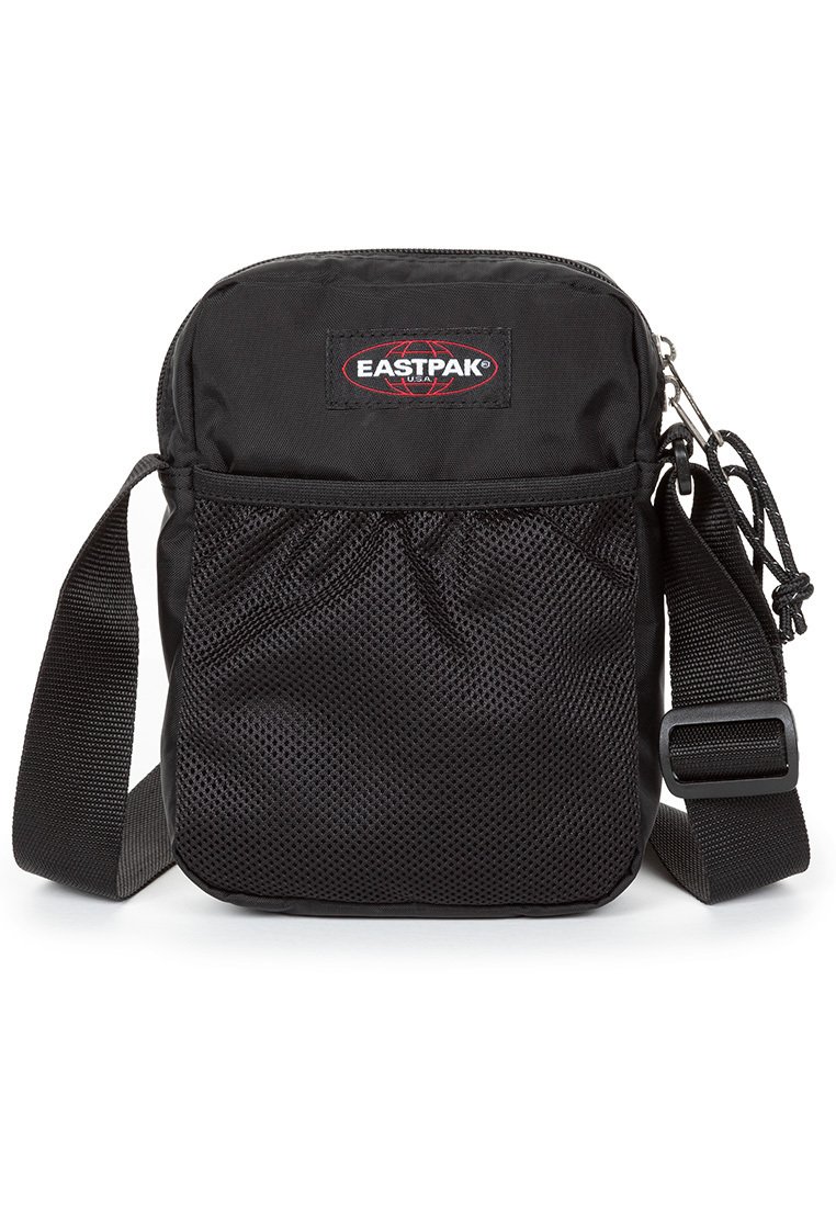 Borsa a tracolla Eastpak nera con chiusura a zip, tasca frontale in rete, tracolla regolabile e patch con logo. Realizzata in tessuto resistente con una superficie liscia.