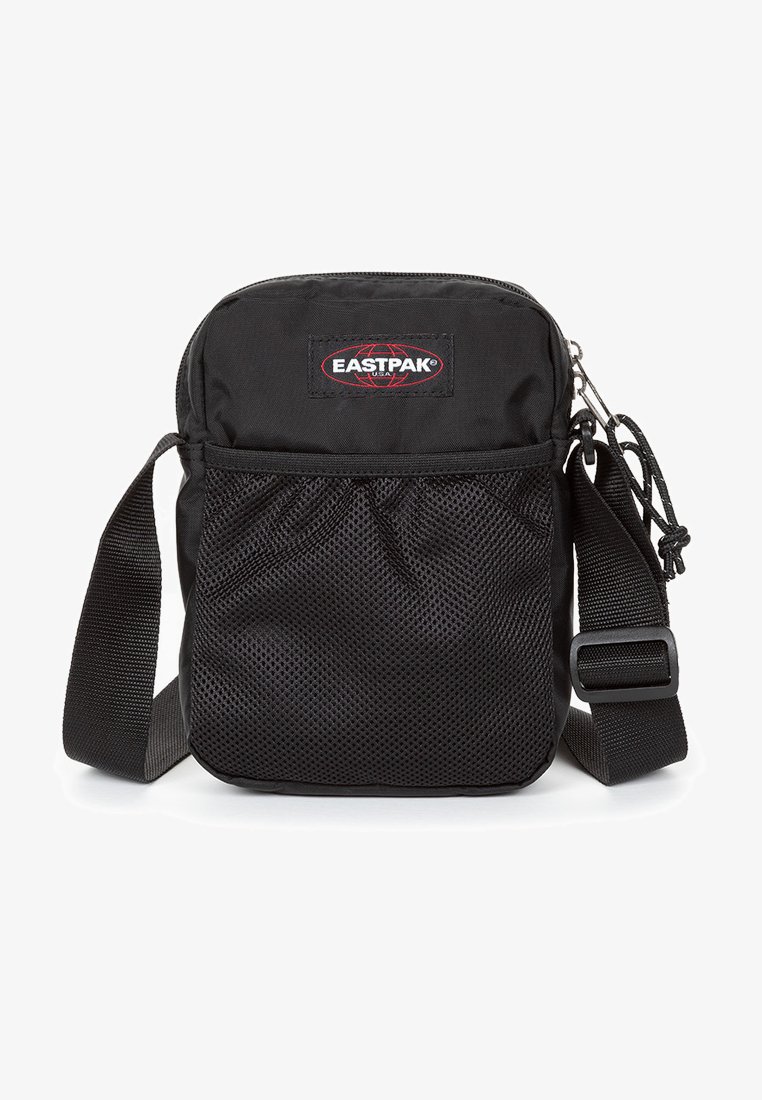 Borsa a tracolla Eastpak nera con chiusura a zip, tasca frontale in rete, tracolla regolabile e patch con logo. Realizzata in tessuto resistente con una superficie liscia.