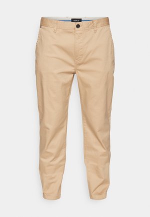 Beige chinos with a slender fit, made from cotton, featuring a standard button closure, side pockets, and a smooth texture.