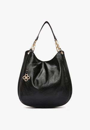 Sac à main hobo en cuir noir avec des maillons de chaîne dorée sur la sangle et un charm décoratif doré, corps souple et décontracté, sans nom de marque ni logo visible.