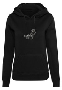 Sweat-shirt à capuche noir avec une poche avant, arborant un texte blanc "spring VIBES" et un design graphique floral. Tissu doux et poignets côtelés.