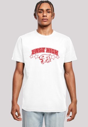 White cotton t-shirt featuring red "EAST HIGH" text, a wildcat graphic, and star accents, with a standard crew neck and short sleeves.