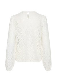 White lace blouse with long sleeves, featuring a floral pattern, a keyhole back detail, and a button closure at the neckline.