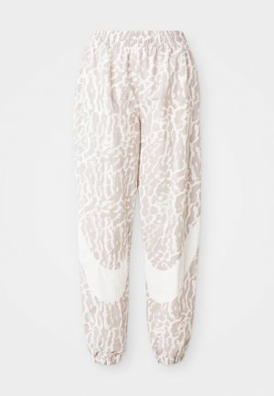 Lichte, gestreepte joggers in lichtroze met een abstract ontwerp. Beschikt over een elastische tailleband en boorden voor een comfortabele pasvorm.