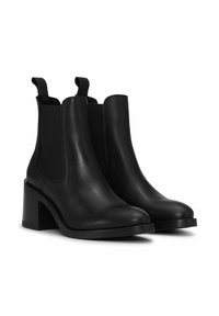 Black leather ankle boots with elastic side panels, a rounded toe, and a chunky heel. Smooth texture with minimal hardware details.