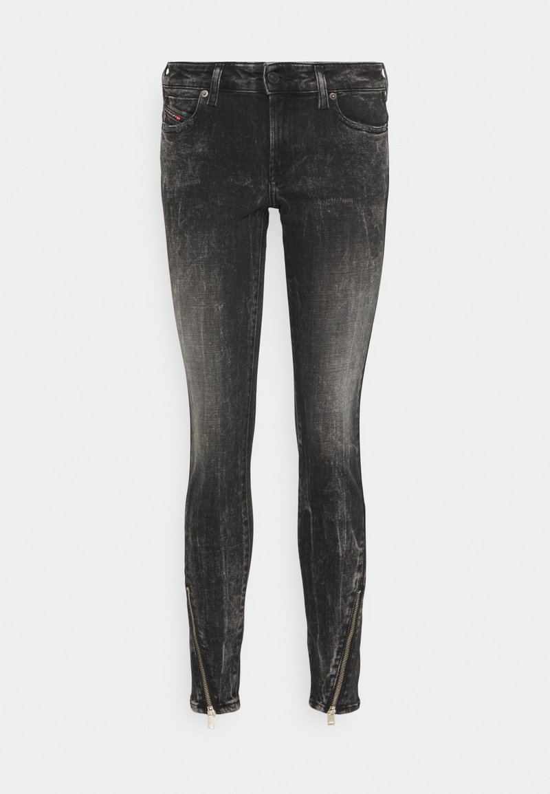 Skinny jeans in faded black denim with a brushed texture. Features zippers at the ankle and classic five-pocket design.