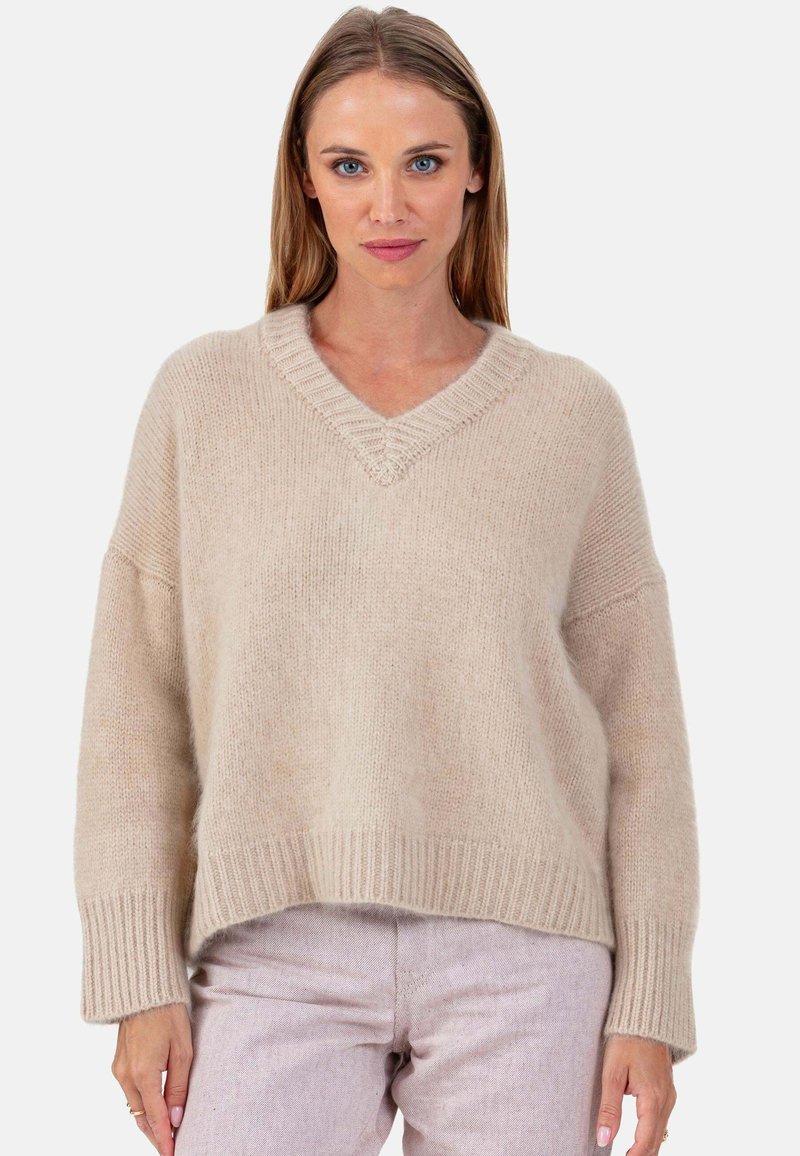 Beiger Pullover aus Wollmischung mit V-Ausschnitt und gerippten Bündchen; zeichnet sich durch eine lockere Passform und eine weiche Textur mit dezenten Farbnuancen aus.