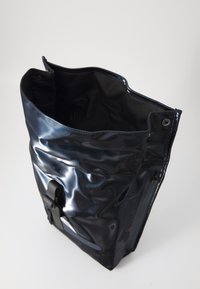 Dark blue, glossy backpack with a top opening, featuring a buckle and side zipper, set against a plain white background.